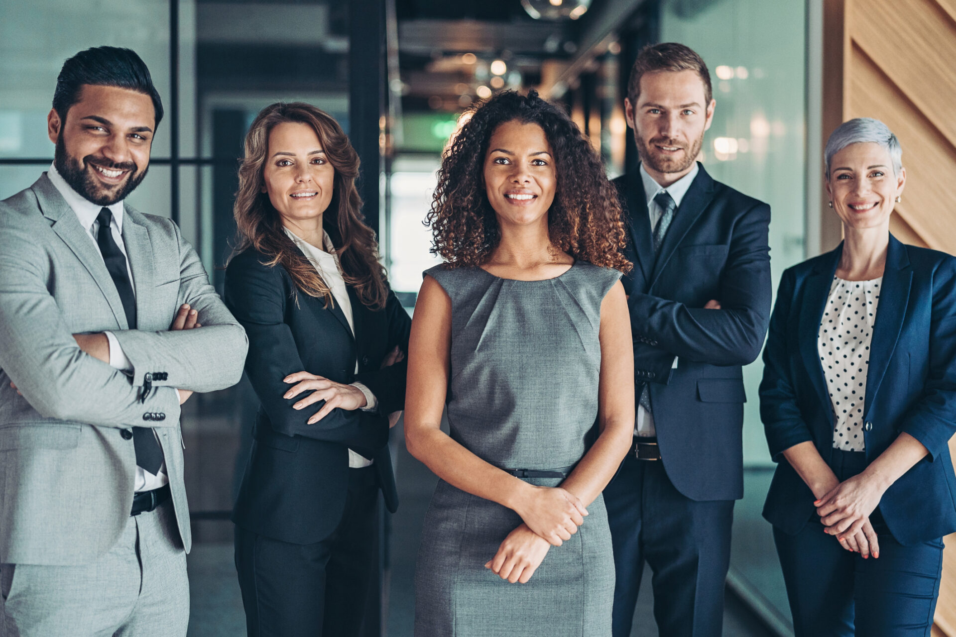 Multi-ethnic group of business persons standing side by side